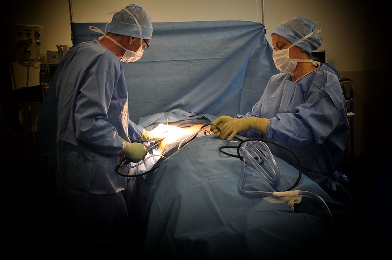 Doctors performing liposuction surgery